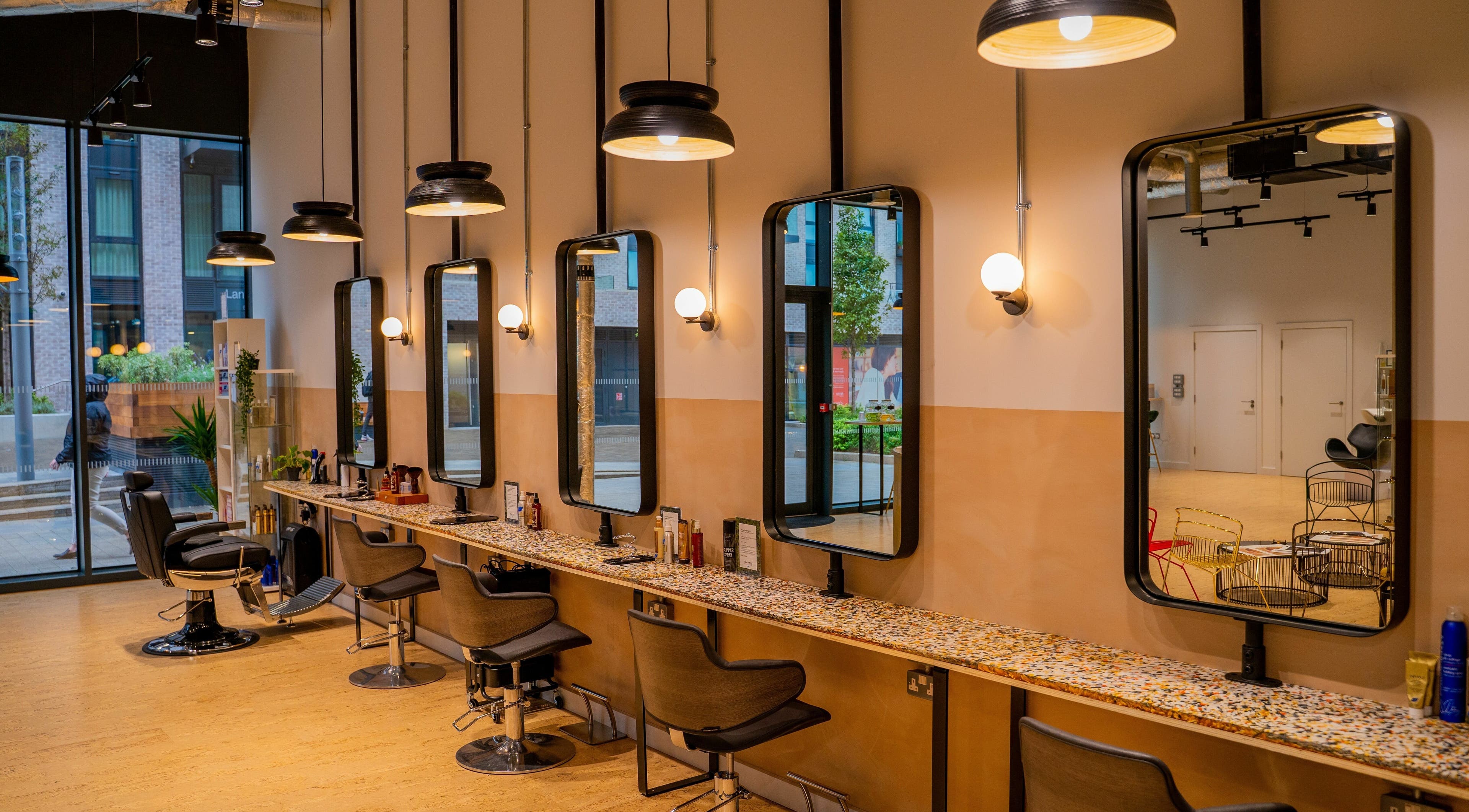 Elegant salon interior at Chop Chop London Wembley Park, Park, London, England, GB featuring stylish mirrors and chairs.