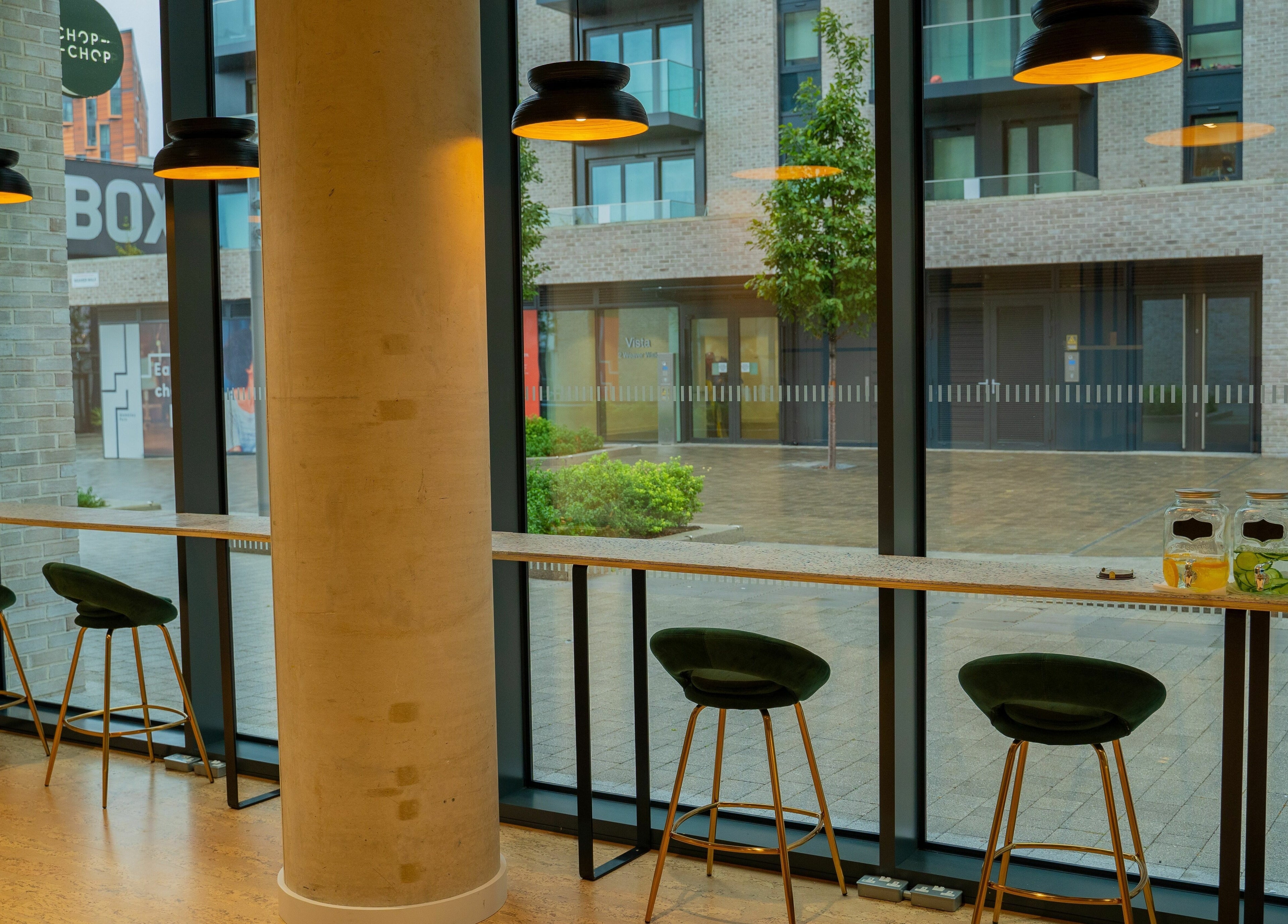 Cozy seating by floor-to-ceiling windows at Chop Chop London Wembley Park, Park, London, England, GB.