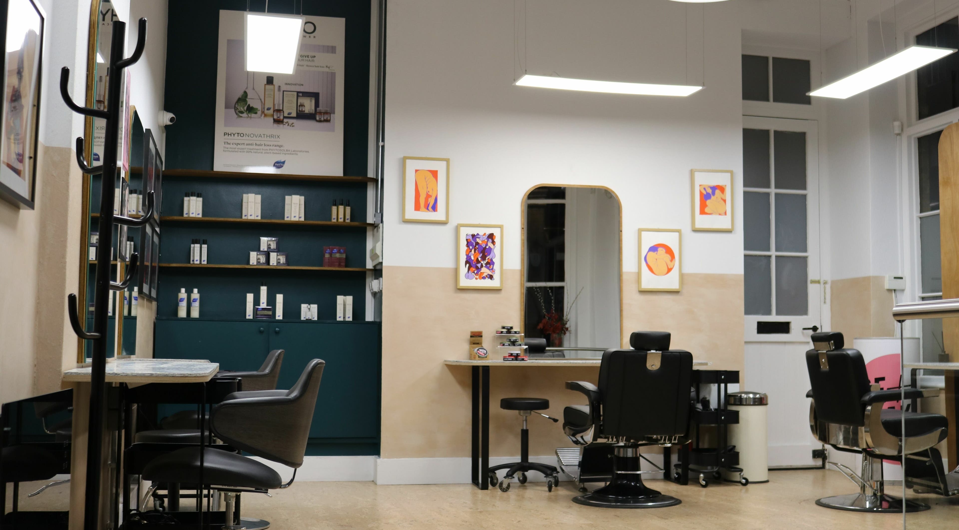 Modern salon interior at Chop Chop London Old Street, London, England, GB with styling chairs and product shelves.