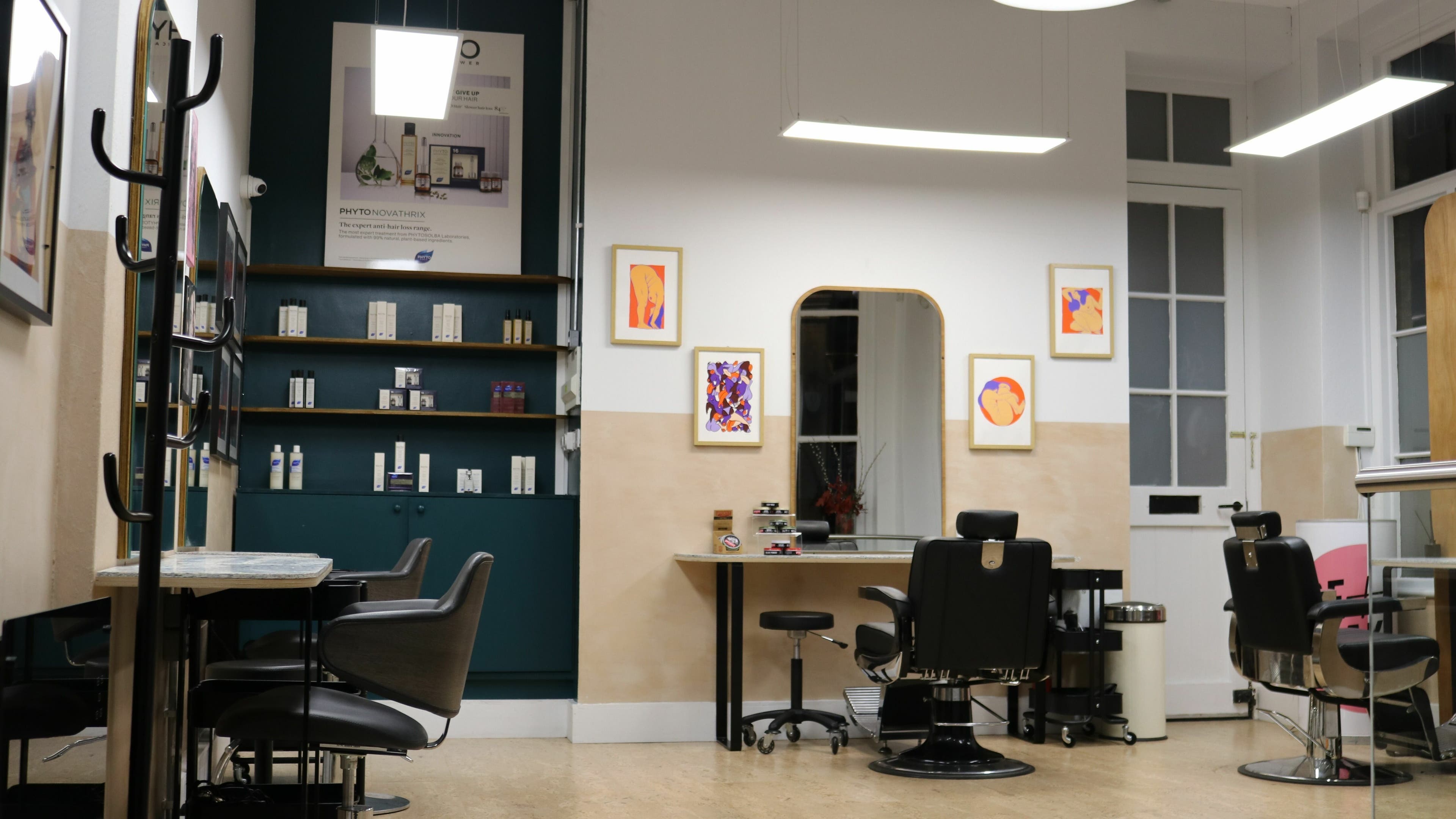 Modern salon interior at Chop Chop London Old Street, London, England, GB with styling chairs and product shelves.