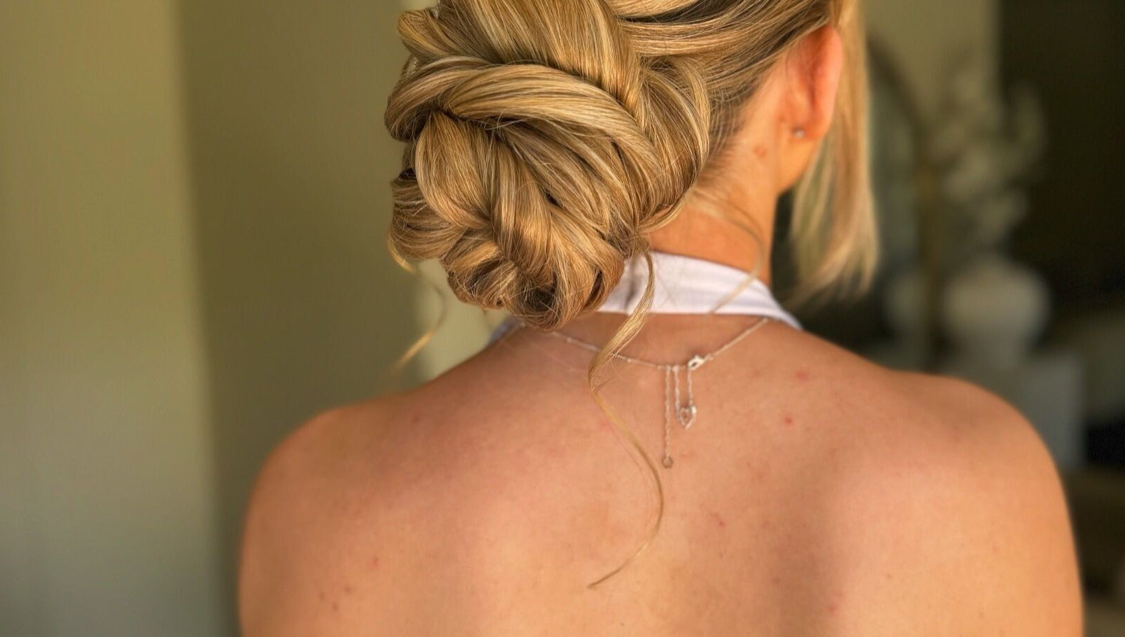 Elegant hairstyle at Lucisbeautyroom, Redlodge, England, GB. Blonde hair styled in an intricate bun.