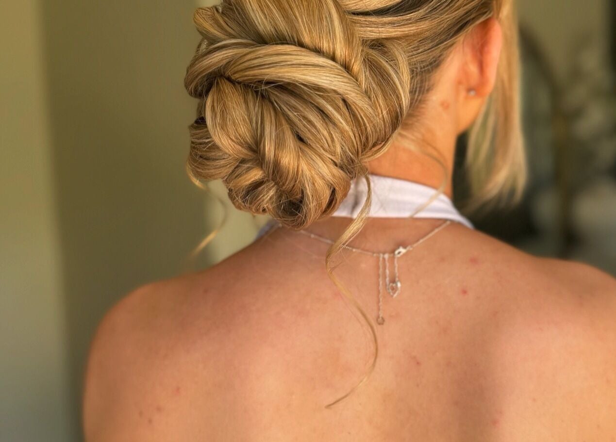 Elegant hairstyle at Lucisbeautyroom, Redlodge, England, GB. Blonde hair styled in an intricate bun.