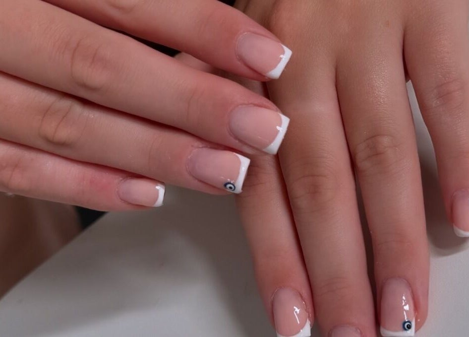 Stylish French manicure at Lucisbeautyroom, Redlodge, England, GB. Elegant nail art design displayed.