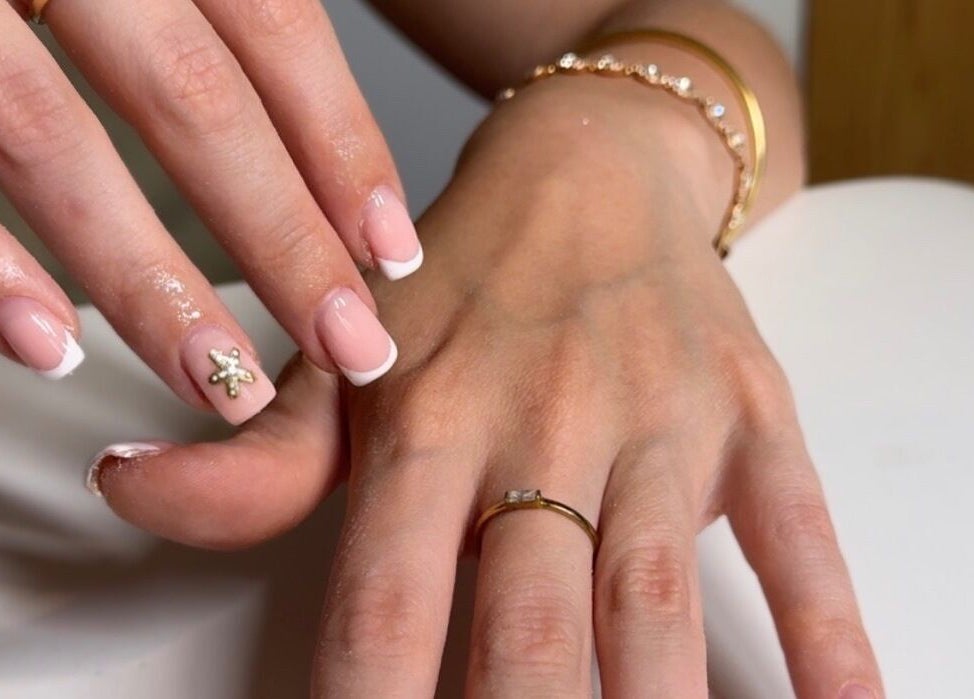 Elegant nail design at Lucisbeautyroom, Redlodge, England, GB. Featuring French tips and gold accents.