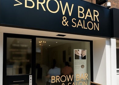 Entrance of VIP Brow Bar and Salon in Newcastle-under-Lyme, England, GB with modern signage.