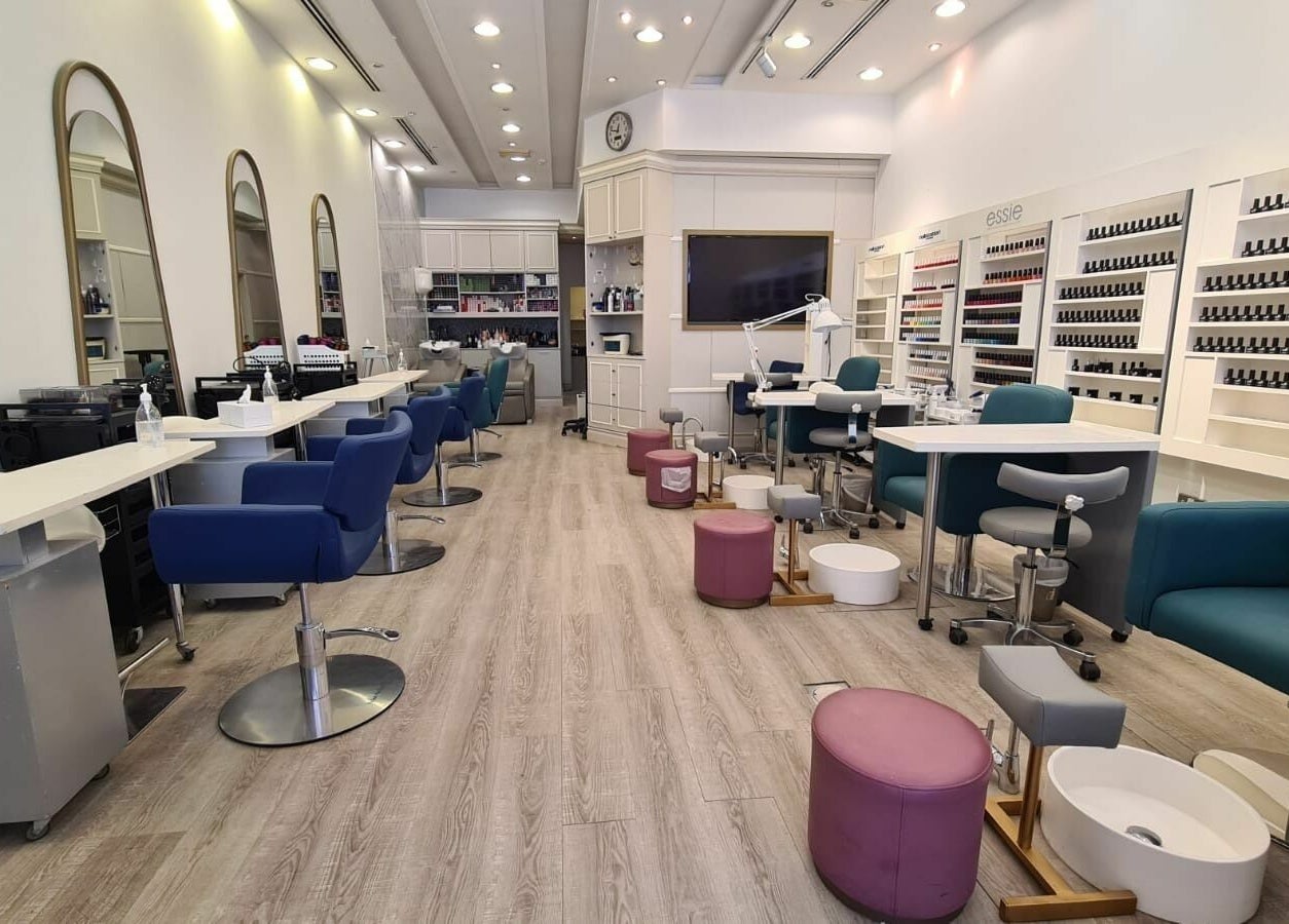 Modern interior of Front Row Salon in Dubai, AE, showcasing sleek styling stations and nail care area.
