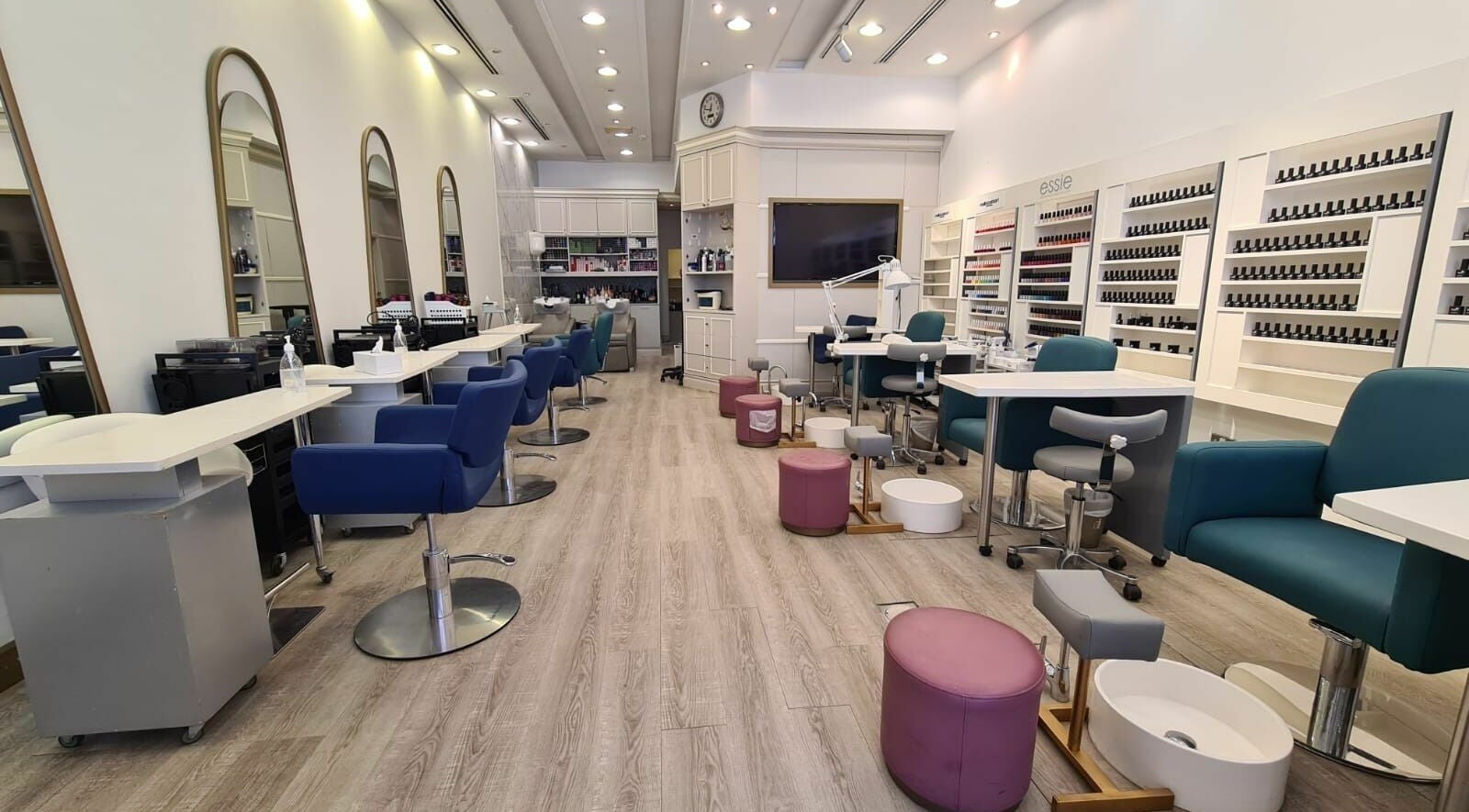 Modern interior of Front Row Salon in Dubai, AE, showcasing sleek styling stations and nail care area.