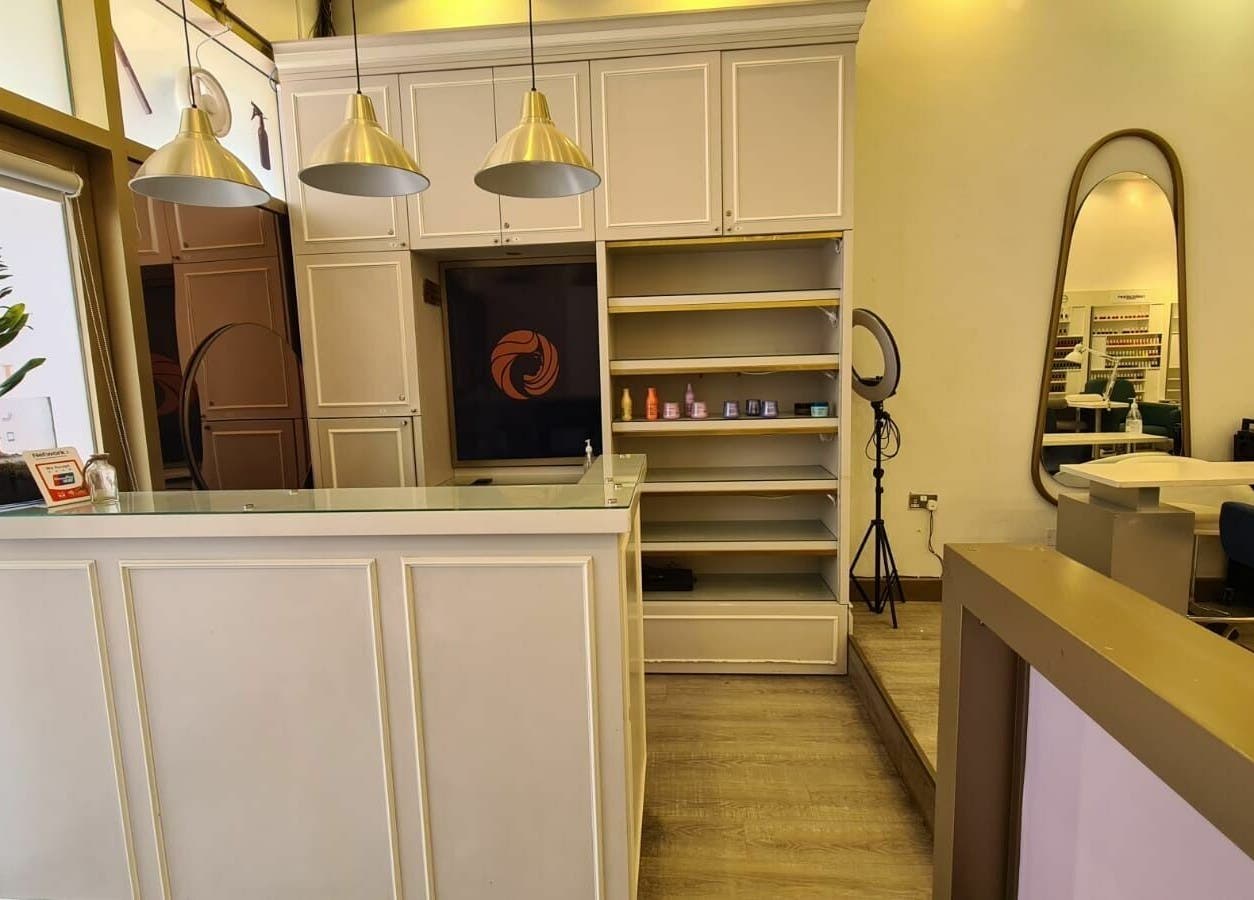 Sophisticated reception area at Front Row Salon, Dubai, AE, with modern decor and ambient lighting.