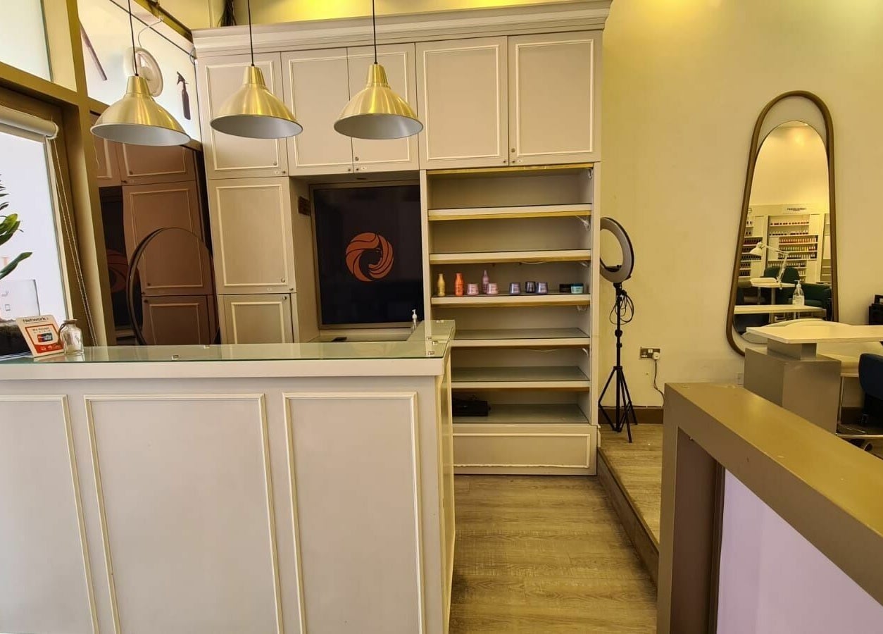 Sophisticated reception area at Front Row Salon, Dubai, AE, with modern decor and ambient lighting.