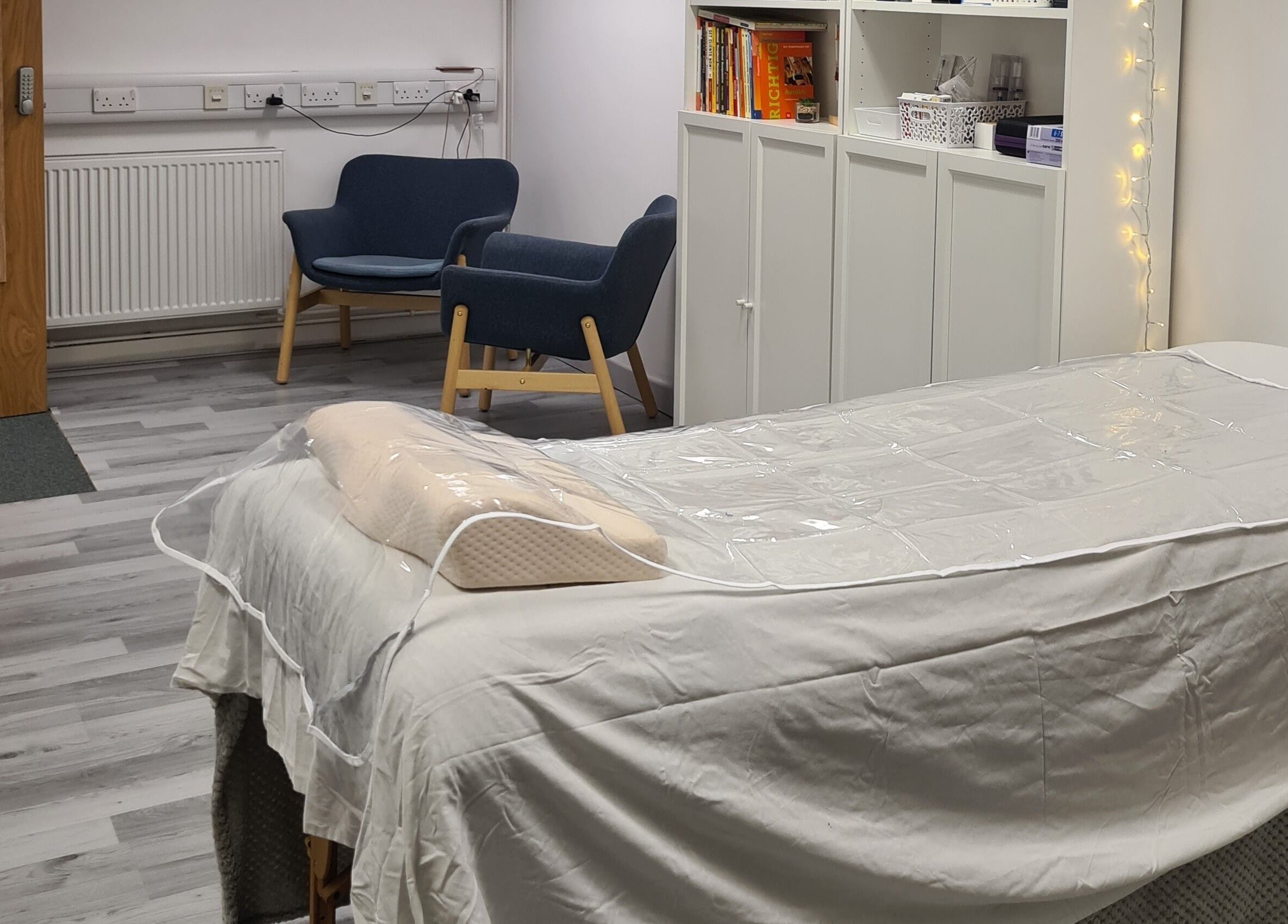 Tranquil therapy room at Diamond Aesthetics Kent, Whitstable, England, GB with a treatment bed and seating area.