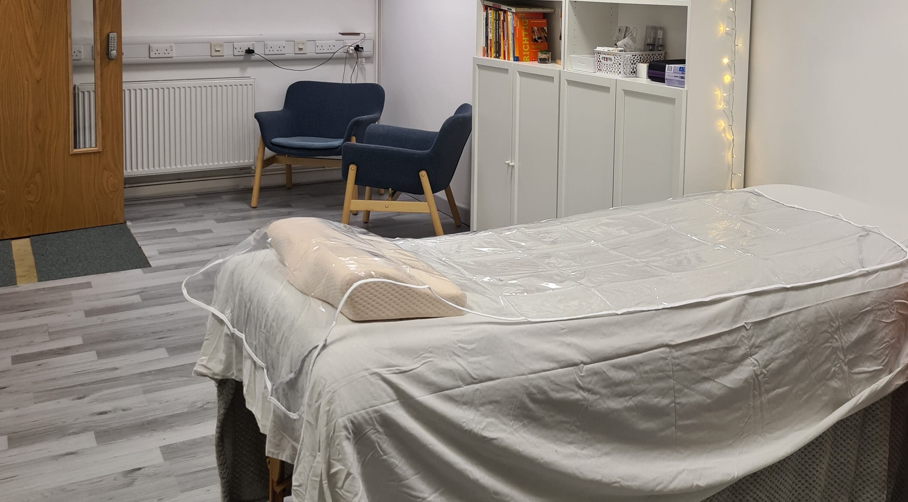 Tranquil therapy room at Diamond Aesthetics Kent, Whitstable, England, GB with a treatment bed and seating area.