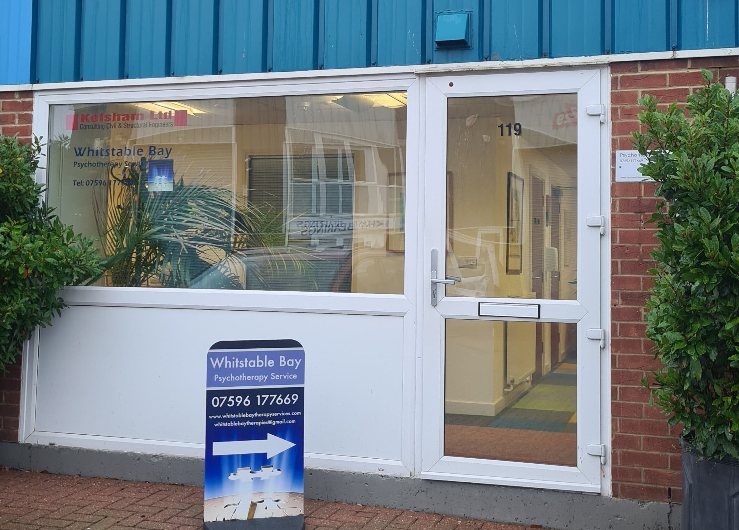 Front entrance of Diamond Aesthetics Kent at Whitstable, England, GB, with clear signage and greenery.