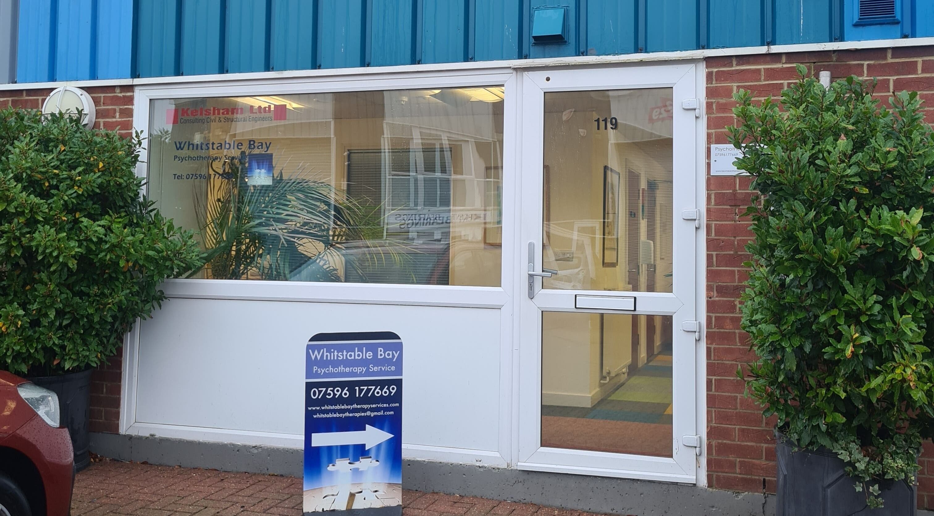 Front entrance of Diamond Aesthetics Kent at Whitstable, England, GB, with clear signage and greenery.