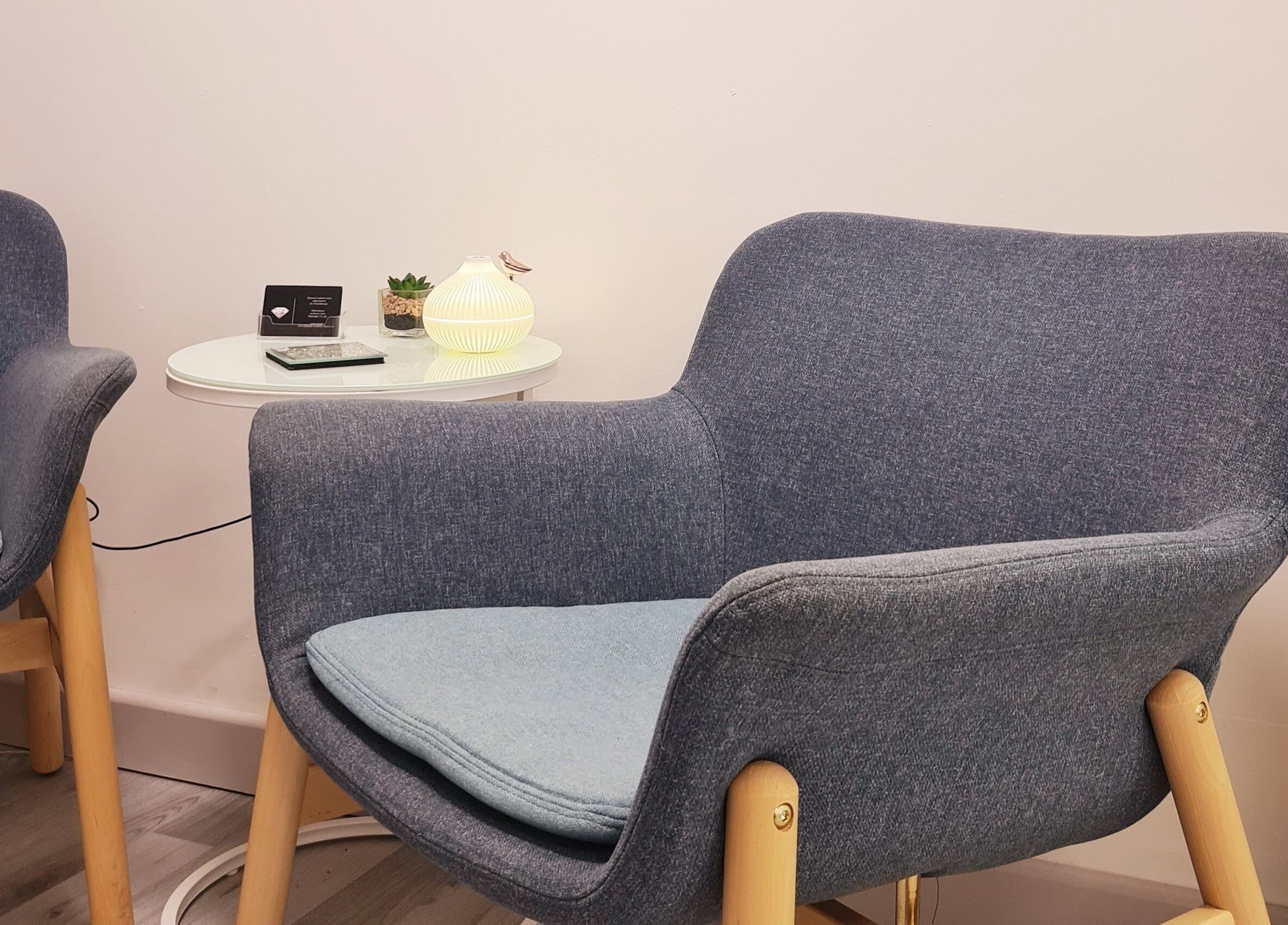 Modern chairs with warm lighting at Diamond Aesthetics Kent, Whitstable, England, GB.