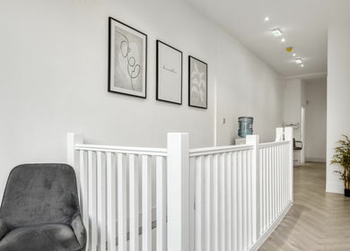 Serene hallway in Simply Clinics - Chelsea, London featuring modern decor and artwork.