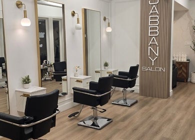 Stylish interior of Hair By Dawn at Jabbany Hair Salon, Ottawa, Ontario, CA featuring sleek black chairs and mirrors.