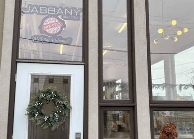 Entrance of Hair By Dawn at Jabbany Hair Salon in Ottawa, Ontario, CA, featuring a welcoming wreath on the door.