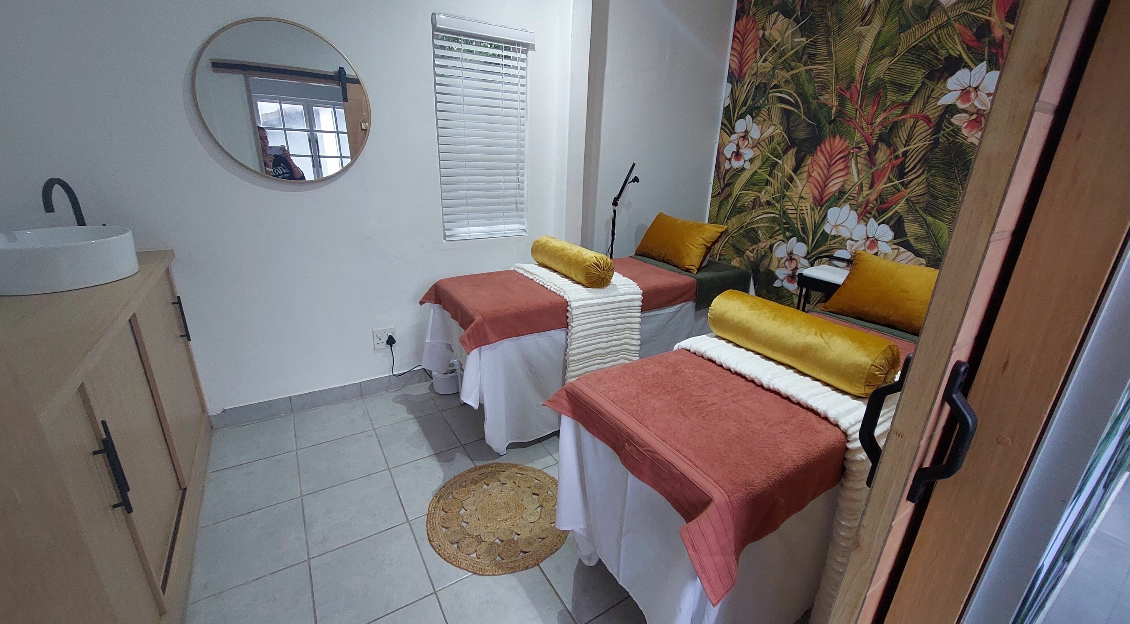 Cozy treatment room at Aesthetique Skin & Body, Durban, KwaZulu-Natal, ZA, with floral decor and twin beds.