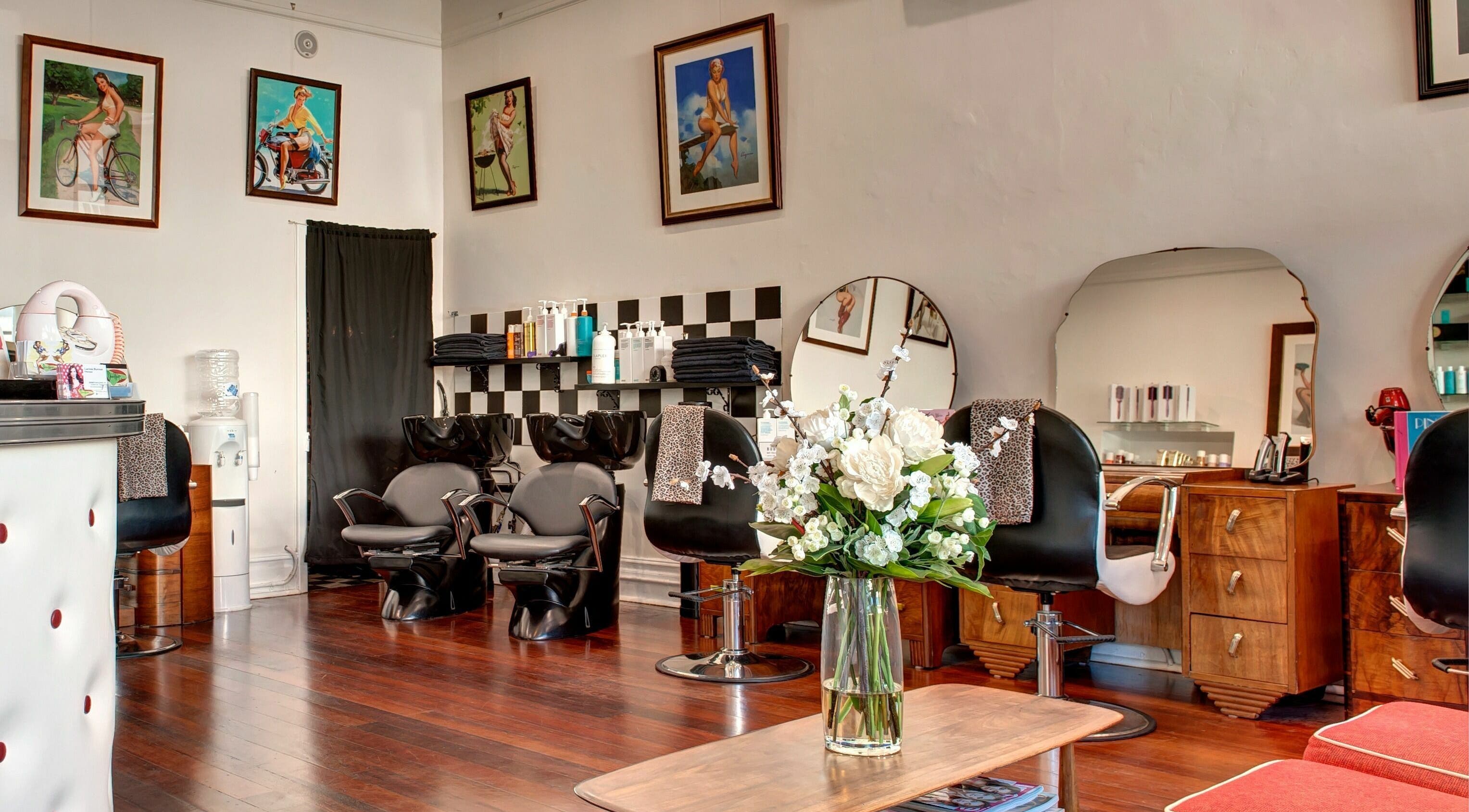 Elegant interior of Doowop Hair, Fremantle, Western Australia, AU with modern chairs and floral decor.