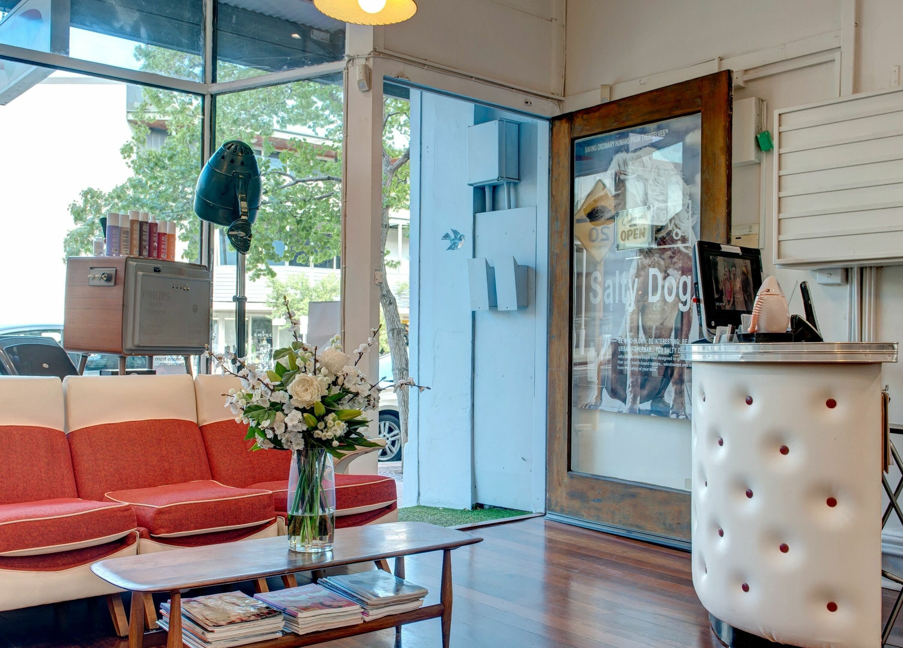 Elegant reception area at Doowop Hair, Fremantle, Western Australia, featuring stylish seating and decor.
