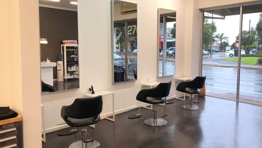 Sleek salon chairs and mirrors at Beyond Blonde, Adelaide, South Australia, AU, offering modern beauty services.