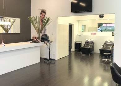 Modern salon interior at Beyond Blonde, Adelaide, South Australia, AU, featuring sleek styling stations and chic decor.