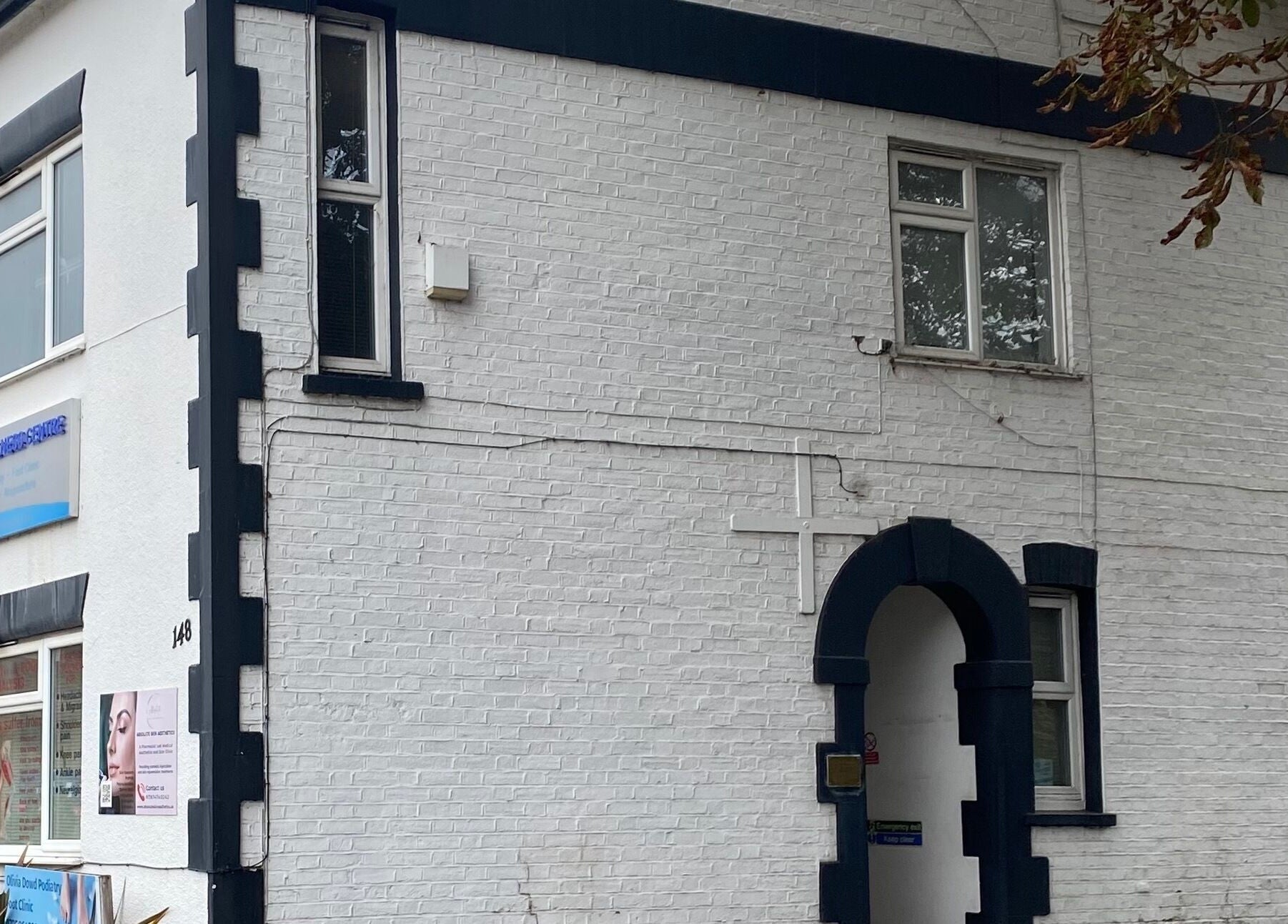 Intuitive Bodywork venue exterior in Rickmansworth, England, GB, showcasing elegant white-brick facade.