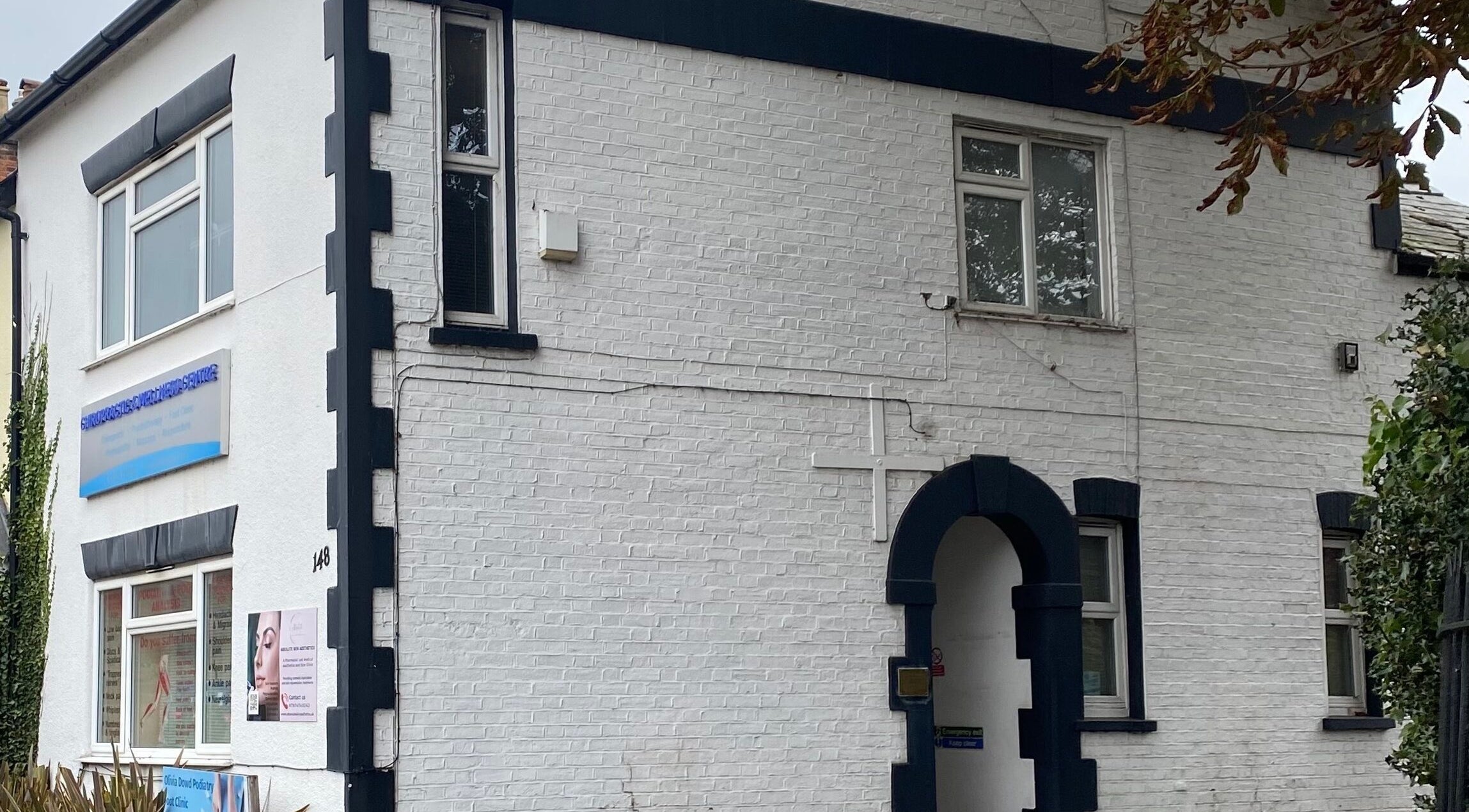 Intuitive Bodywork venue exterior in Rickmansworth, England, GB, showcasing elegant white-brick facade.