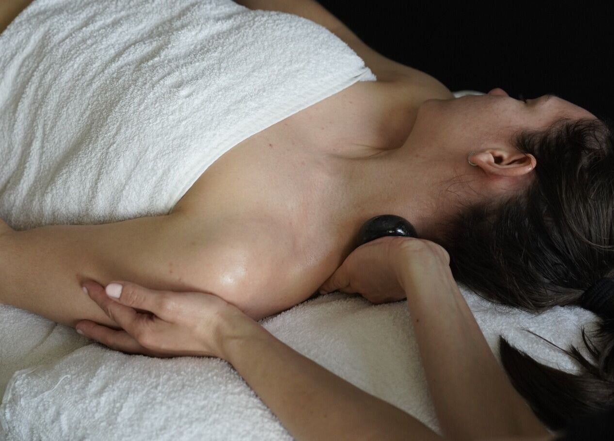 Relaxing hot stone massage at Intuitive Bodywork in Rickmansworth, England, GB.