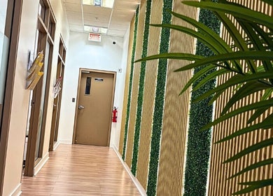 Couloir moderne chez Épilation l’élégance, Brossard, Québec, CA avec mur texturé et décor naturel.