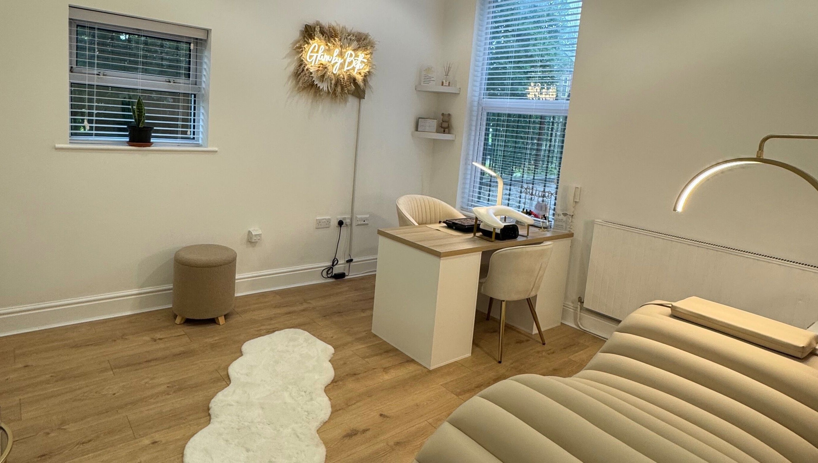 Cozy interior of Glam by Beth in Bolton, England featuring a treatment bed and workstation.