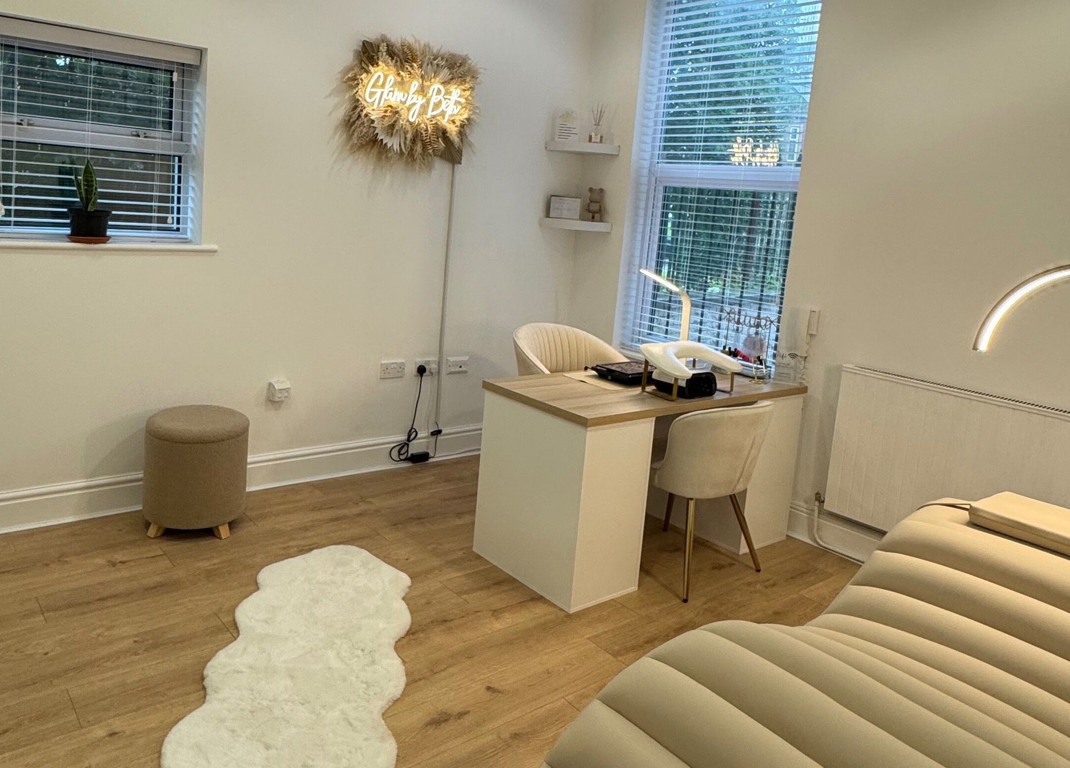 Cozy interior of Glam by Beth in Bolton, England featuring a treatment bed and workstation.
