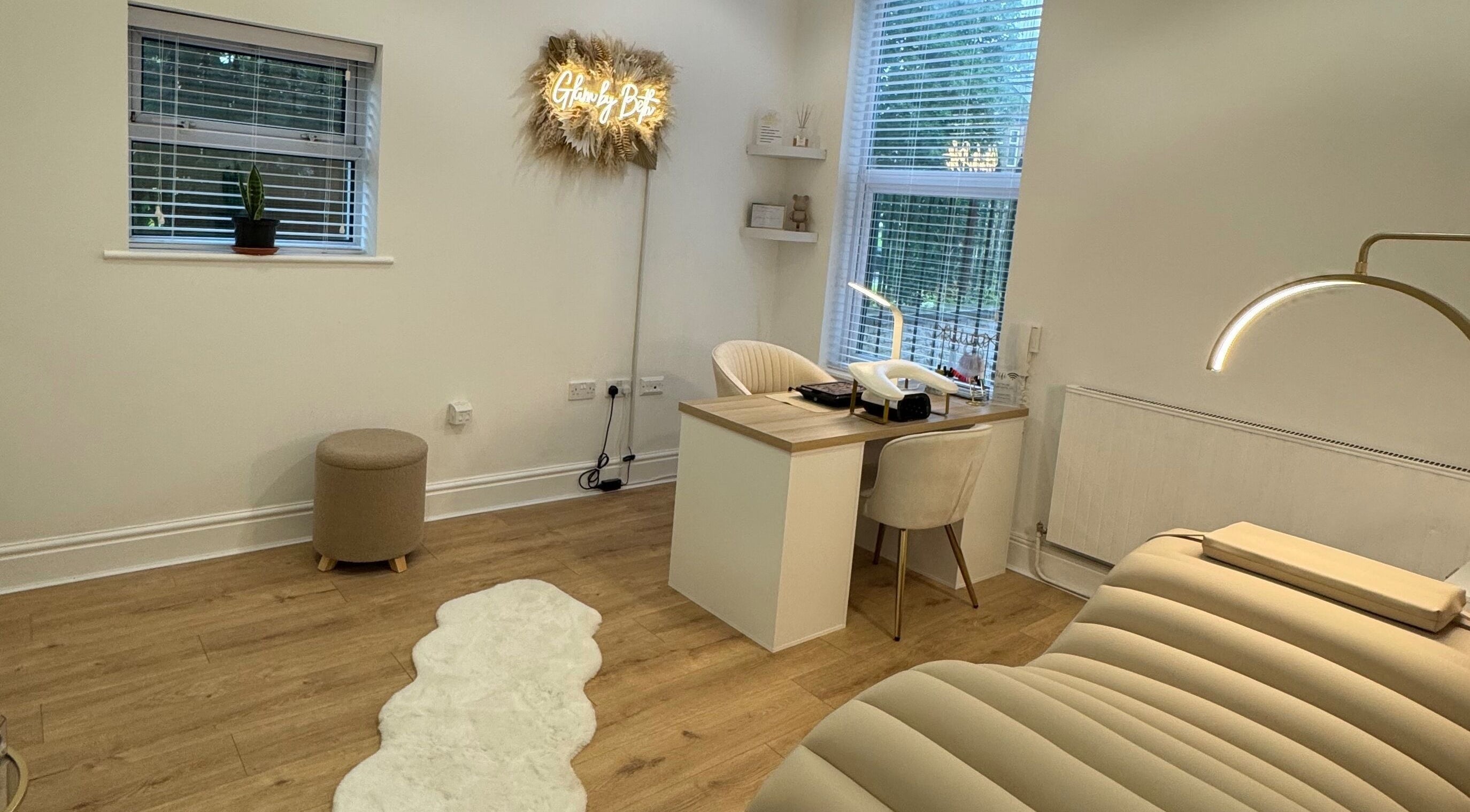 Cozy interior of Glam by Beth in Bolton, England featuring a treatment bed and workstation.