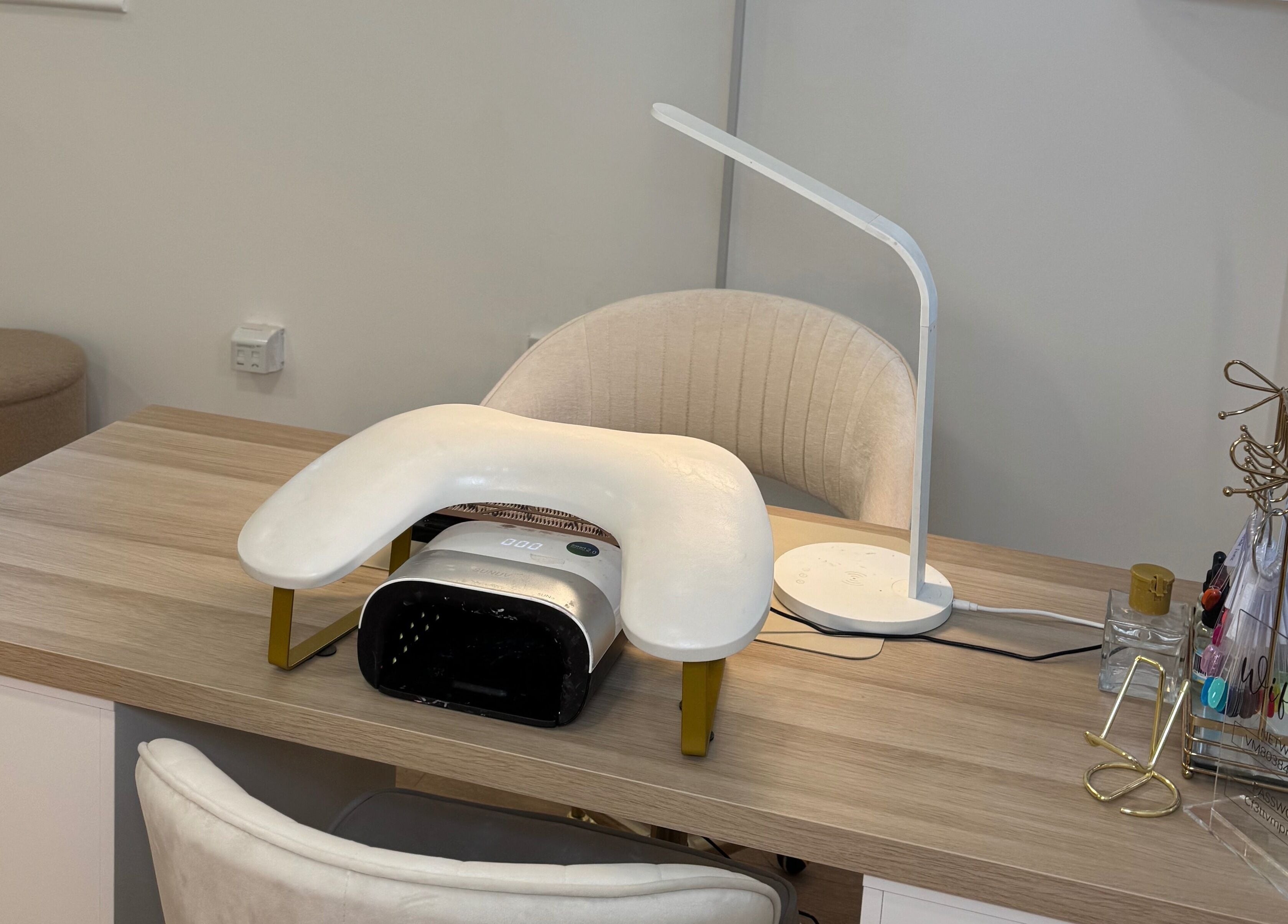 Modern nail station at Glam by Beth, Bolton, England, GB, featuring a stylish lamp and manicure tools.