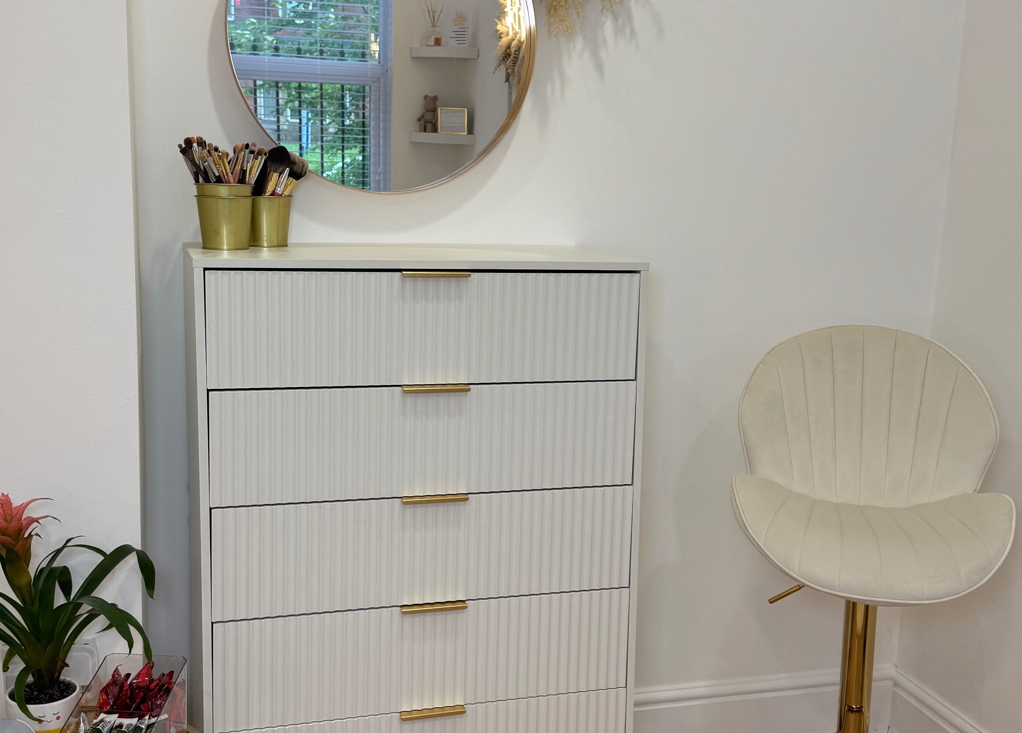 Elegant beauty area at Glam by Beth in Bolton, England, GB, featuring a white dresser and cozy chair.