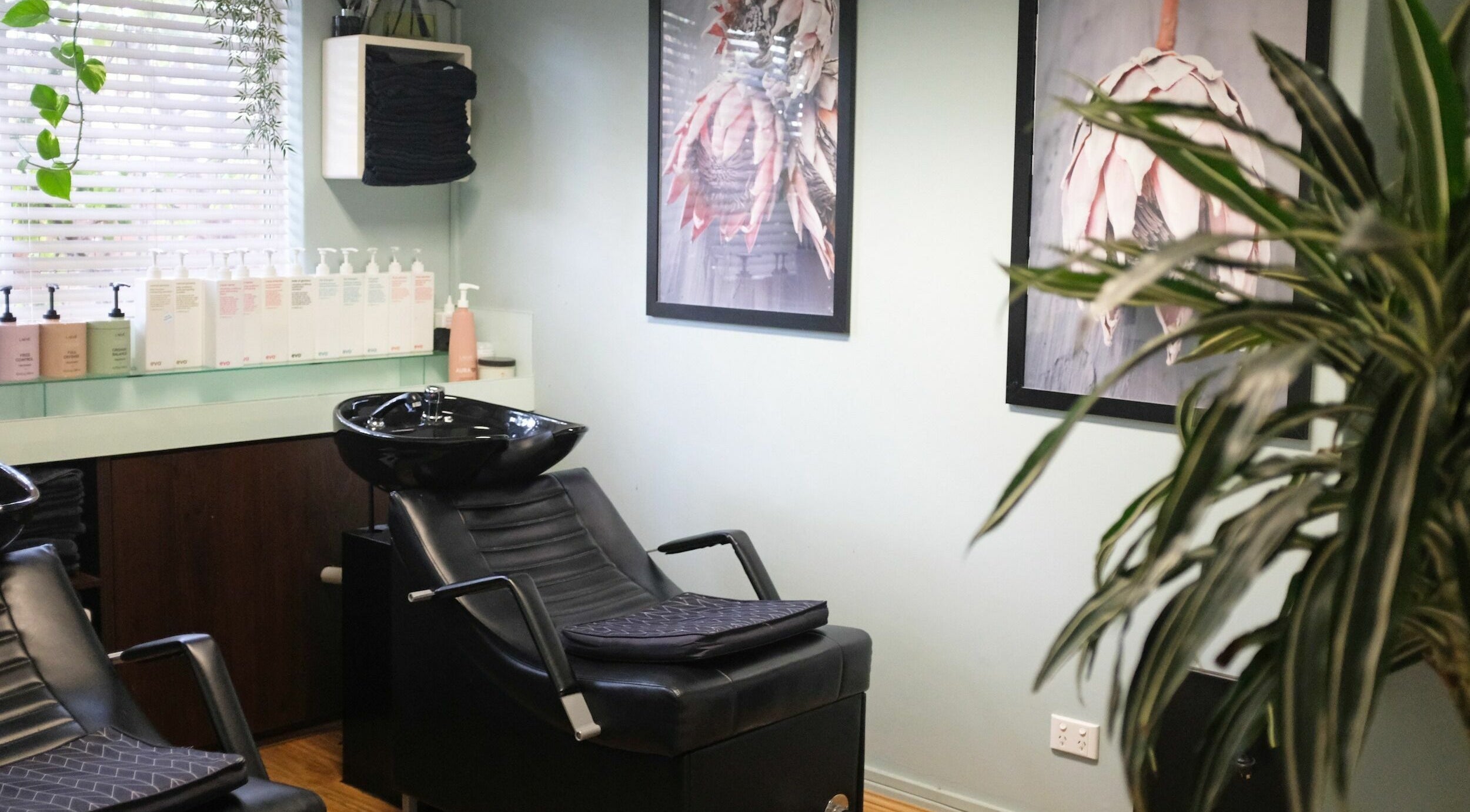 Chic salon interior at Kinks Hair and Beauty, South Fremantle, Western Australia, AU, featuring black wash stations.