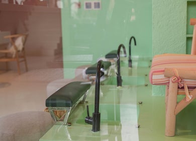 Elegant pedicure station at La Palma Beauty House, الرياض, منطقة الرياض, SA, with chic chairs and green decor.