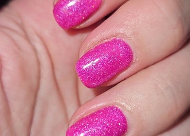 Bright pink glitter nails at All About You, Armadale, Scotland, GB.