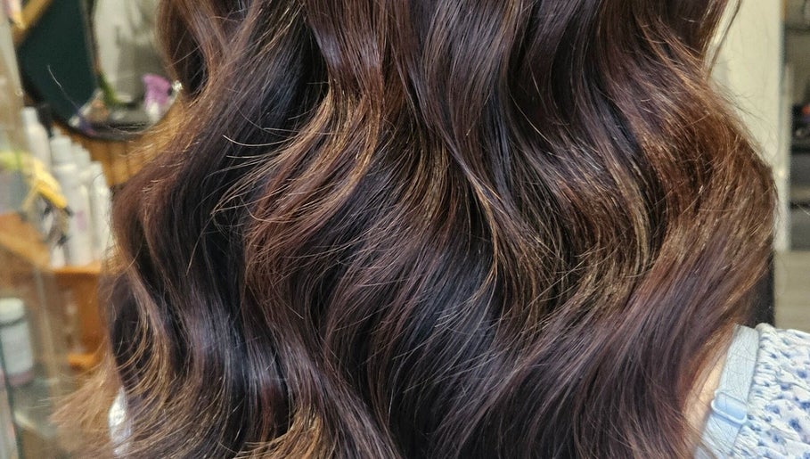 Styled brown hair with glossy waves at All About You, Armadale, Scotland, GB.