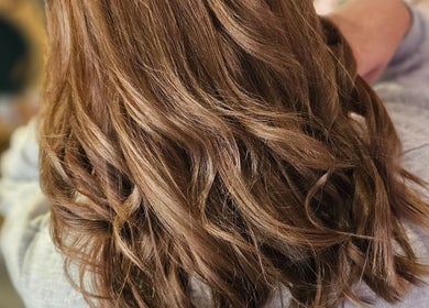 Elegant wavy brown hair styled at All About You, Armadale, Scotland, GB.