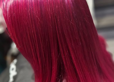 Vibrant red hairstyle at All About You, Armadale, Scotland, GB. Radiant color transformation.