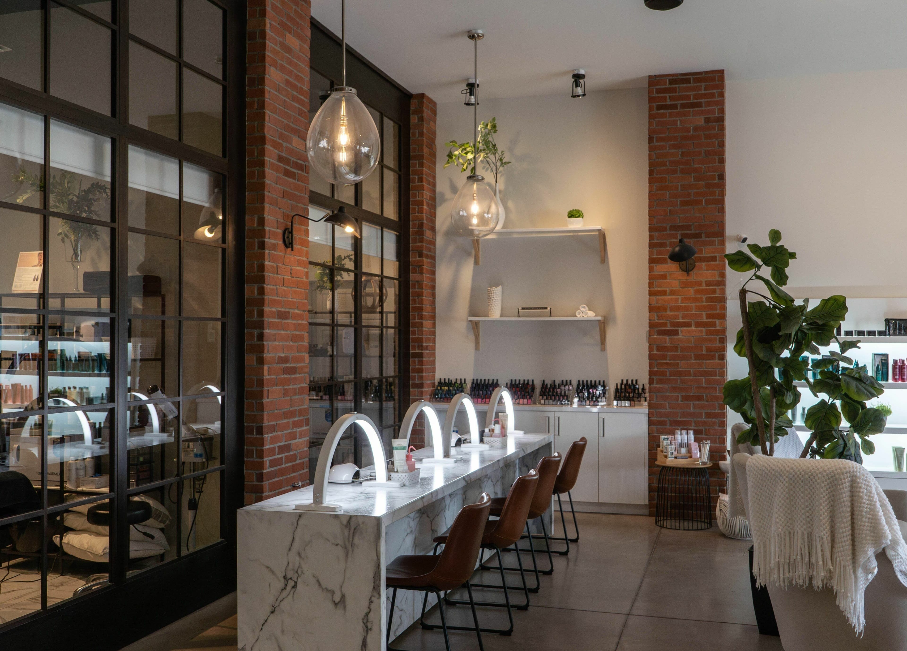 Modern beauty interior at SoFlo & Co North, Moncton, New Brunswick, CA, featuring stylish nail stations and decor.