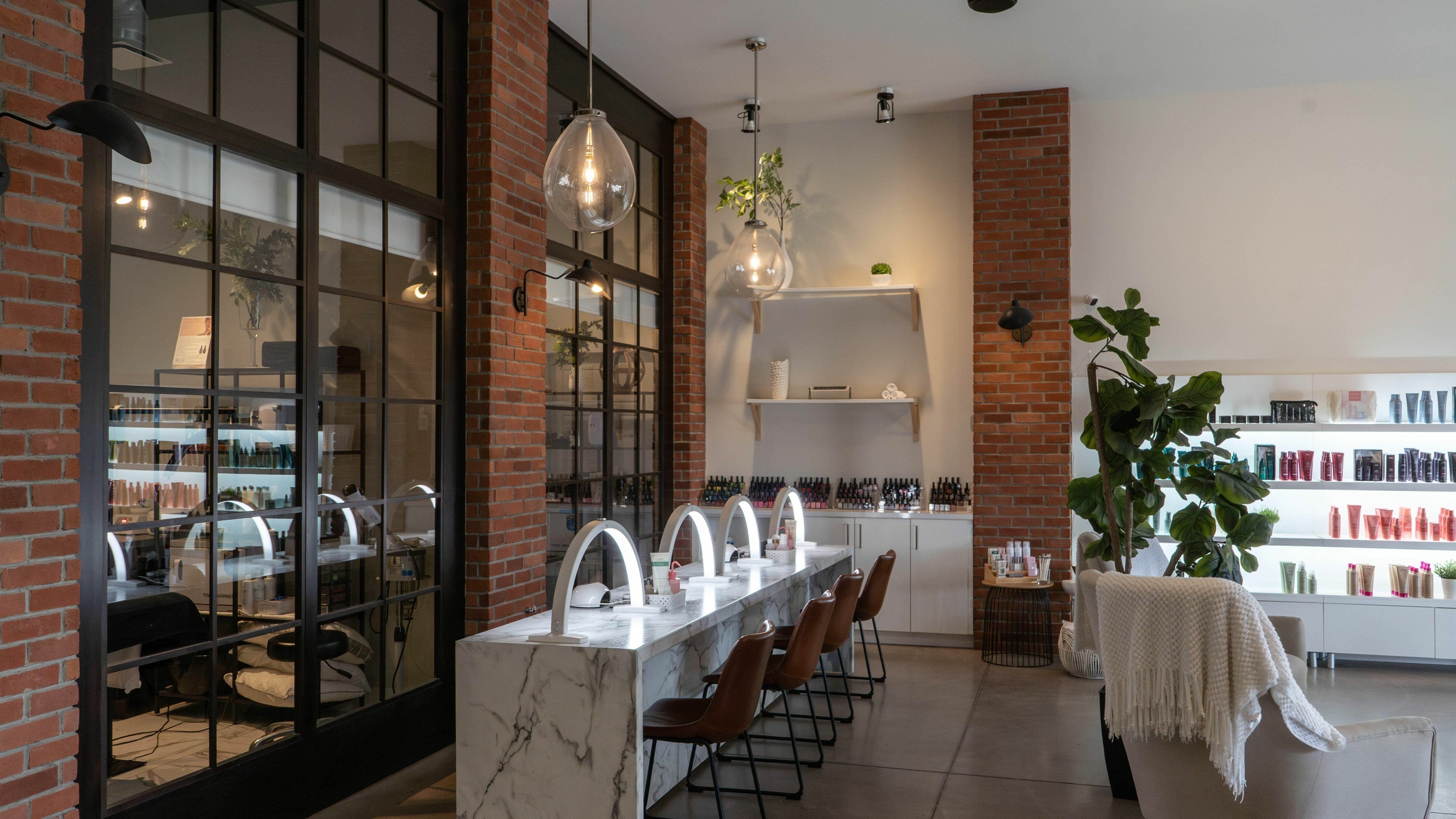 Modern beauty interior at SoFlo & Co North, Moncton, New Brunswick, CA, featuring stylish nail stations and decor.