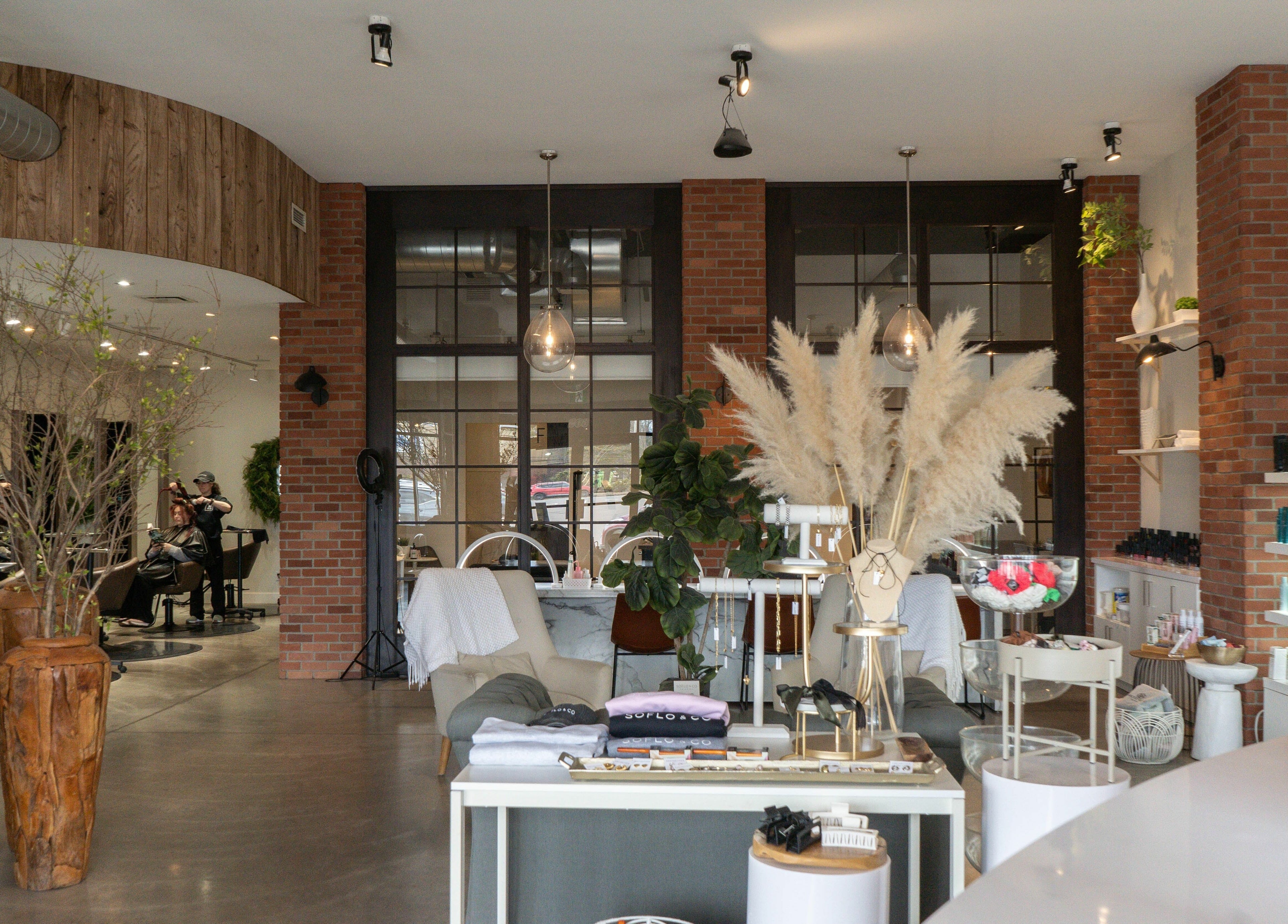Modern interior at SoFlo & Co North, Moncton, New Brunswick, CA showcasing vibrant salon and seating area.