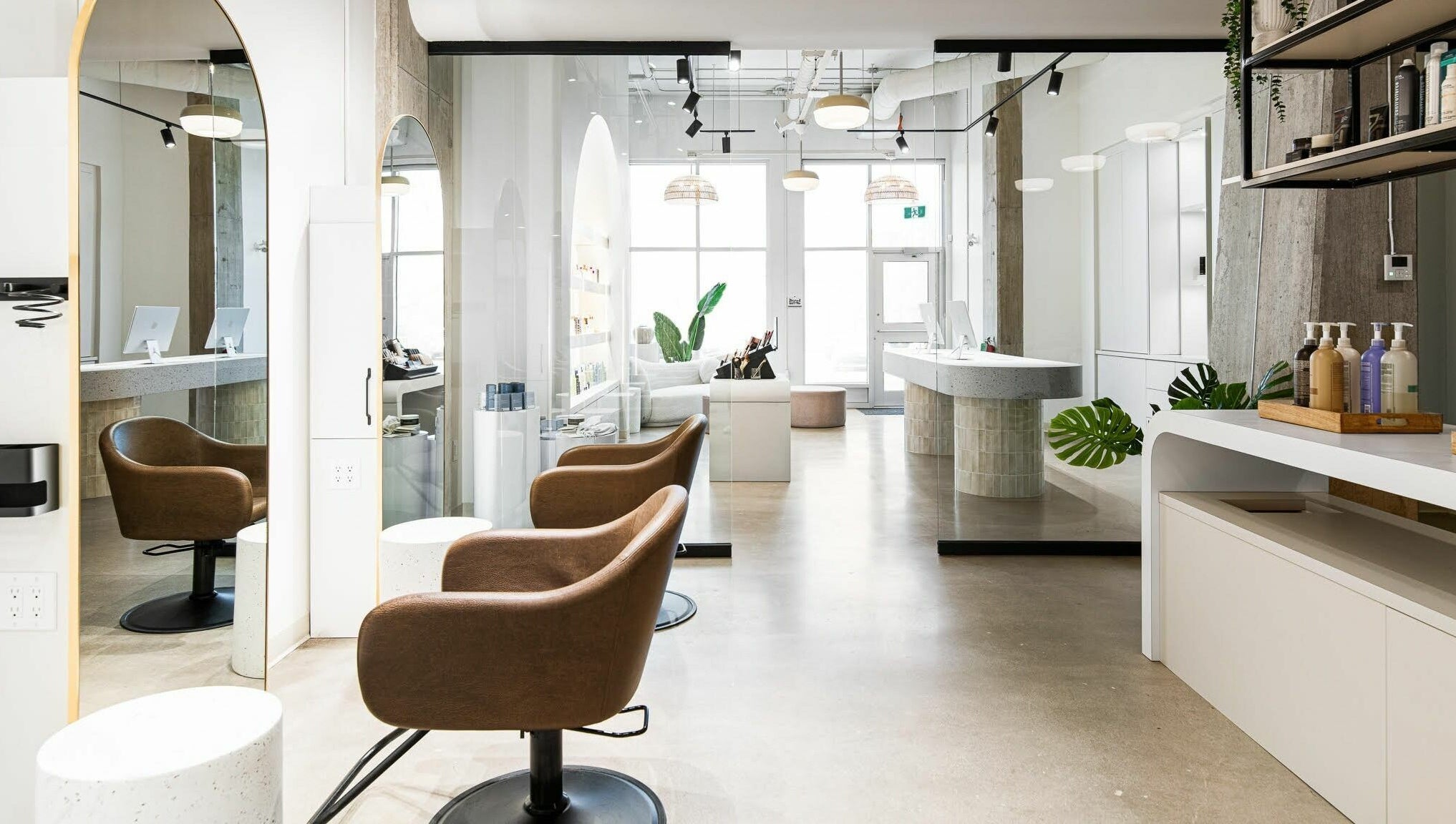 Modern salon interior at SoFlo & Co Tannery, Moncton, New Brunswick, CA, with elegant seating and well-lit decor.
