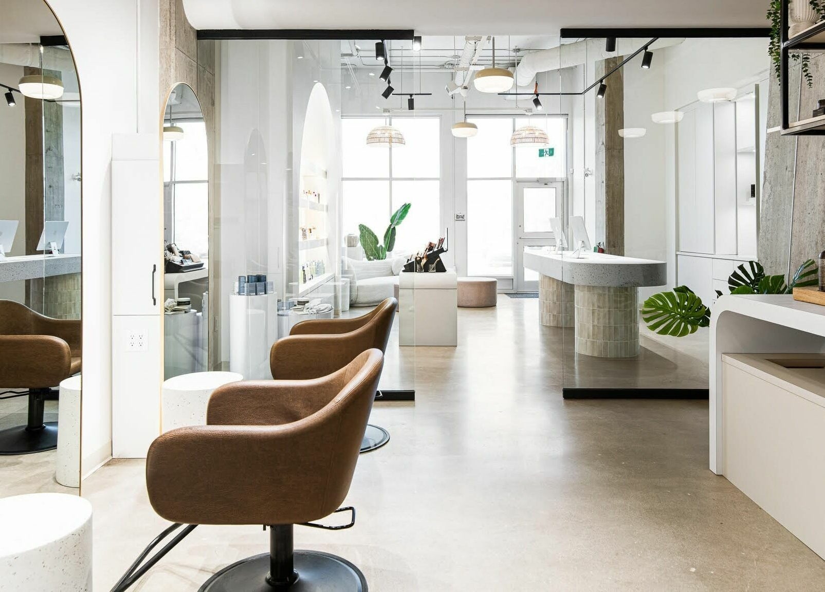 Modern salon interior at SoFlo & Co Tannery, Moncton, New Brunswick, CA, with elegant seating and well-lit decor.