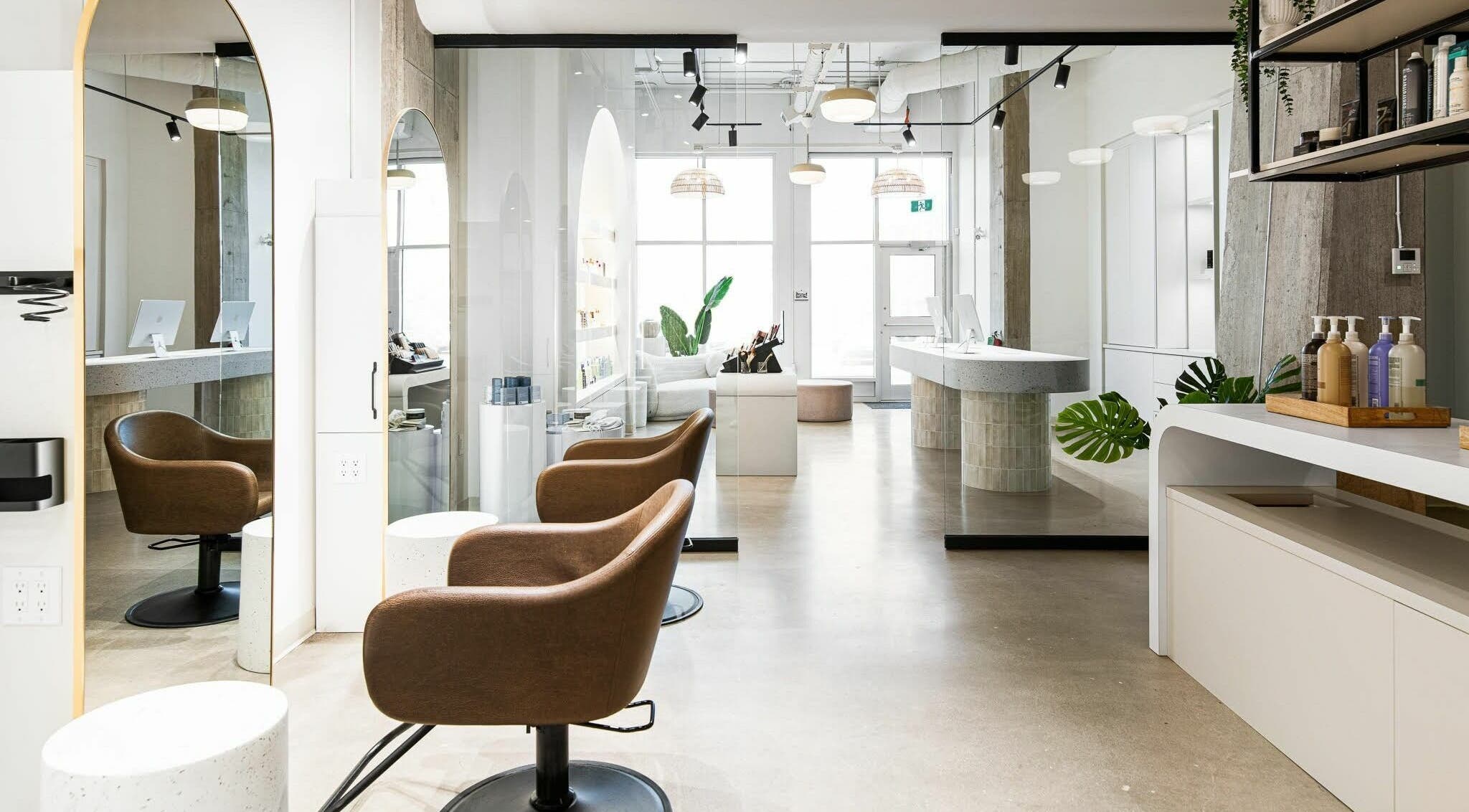 Modern salon interior at SoFlo & Co Tannery, Moncton, New Brunswick, CA, with elegant seating and well-lit decor.