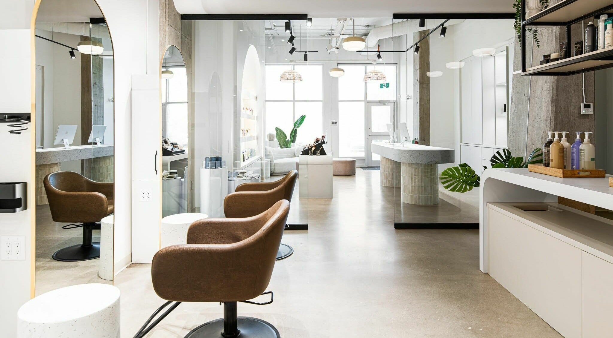 Modern salon interior at SoFlo & Co Tannery, Moncton, New Brunswick, CA, with elegant seating and well-lit decor.