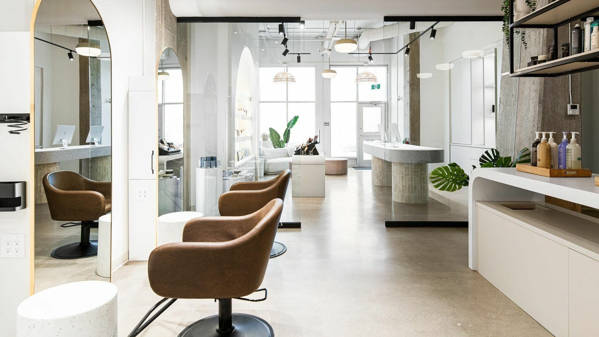 Modern salon interior at SoFlo & Co Tannery, Moncton, New Brunswick, CA, with elegant seating and well-lit decor.