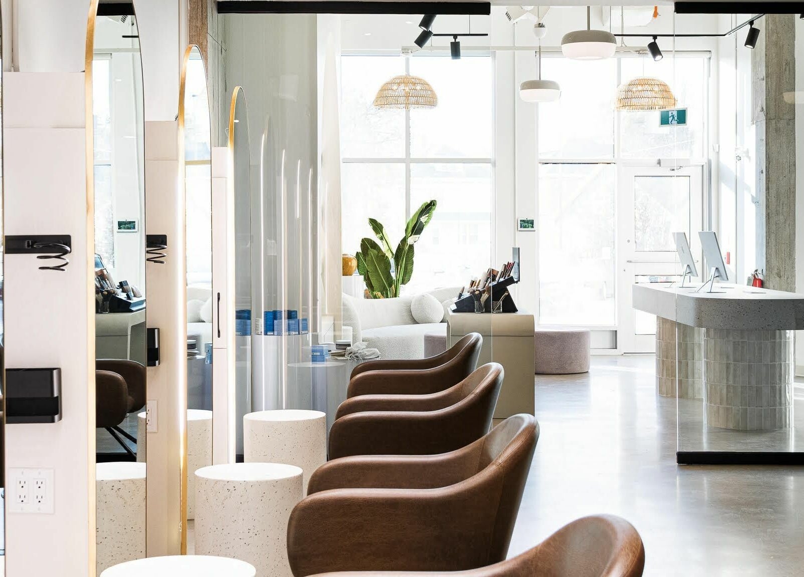 Modern salon interior at SoFlo & Co Tannery, Moncton, New Brunswick, CA. Elegant chairs and natural lighting.